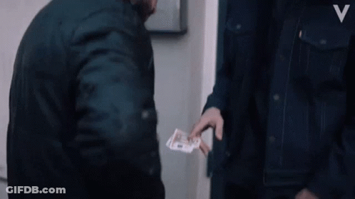 A Man In A Denim Jacket With The Letter V On The Front GIF