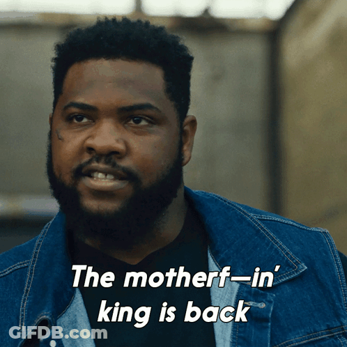 A Man In A Denim Jacket With The Words The Motherf-In King Is Back Below Him GIF