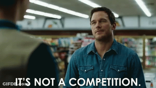 A Man In A Denim Shirt Is Saying It 'S Not A Competition GIF