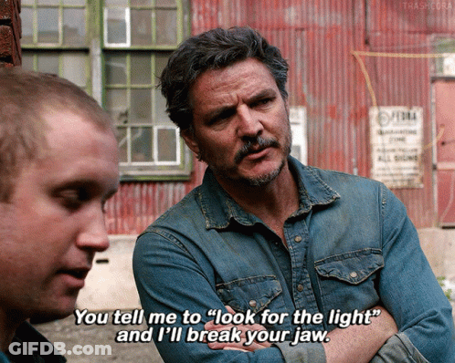 A Man In A Denim Shirt Is Talking To Another Man And Says " You Tell Me To Look For The Light " GIF