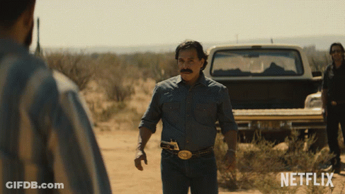 A Man In A Denim Shirt Stands In Front Of A Netflix Truck GIF