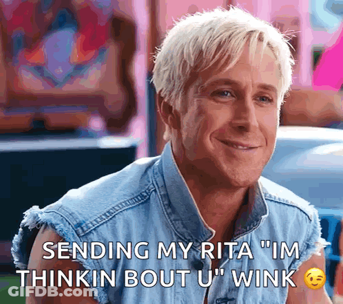 A Man In A Denim Vest Is Smiling And Says " Sending My Rita Im Thinkin Bout U Wink " GIF