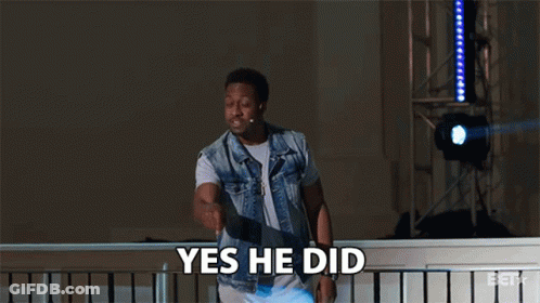 A Man In A Denim Vest Says Yes He Did While Standing On A Balcony GIF