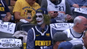 A Man In A Denver Jersey Is Sitting In A Crowd GIF
