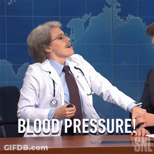 A Man In A Doctor 'S Coat Is Sitting At A Desk And Says Blood Pressure GIF