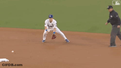 A Man In A Dodgers Jersey Is Running On The Field GIF