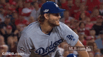 A Man In A Dodgers Jersey Is Smiling GIF