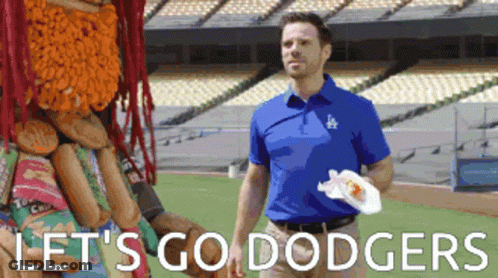 A Man In A Dodgers Shirt Is Standing On A Field GIF