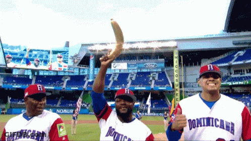 A Man In A Dominicana Jersey Holds A Trophy GIF