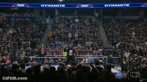 Man In Dynamite Shirt In Front Of Crowd GIF
