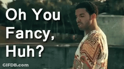 A Man In A Fancy Shirt Is Standing In Front Of A Sign That Says Oh You Fancy Huh ? GIF