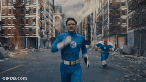 A Man In A Fantastic Four Costume Is Running Down The Street GIF