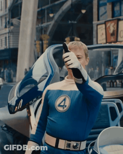 A Man In A Fantastic Four Costume Talks On A Phone GIF