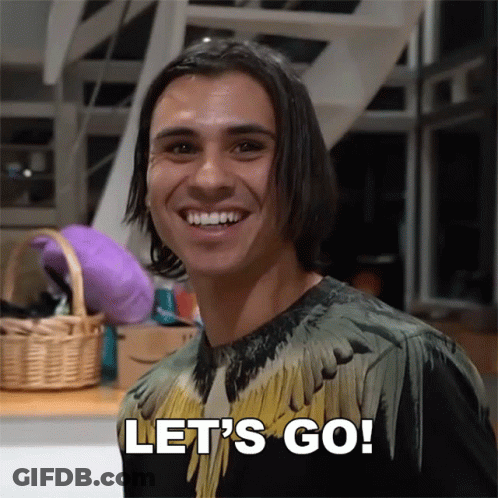 A Man In A Feathered Shirt Is Smiling And Says Let 'S Go GIF