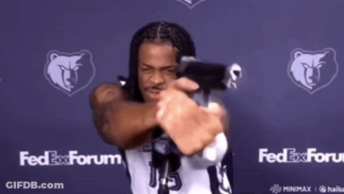 A Man In A Fedex Forum Jersey Is Holding A Gun GIF