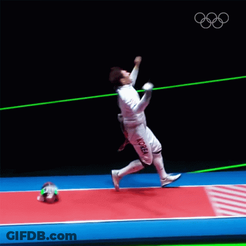 A Man In A Fencing Uniform Is Jumping In The Air With A Sword GIF