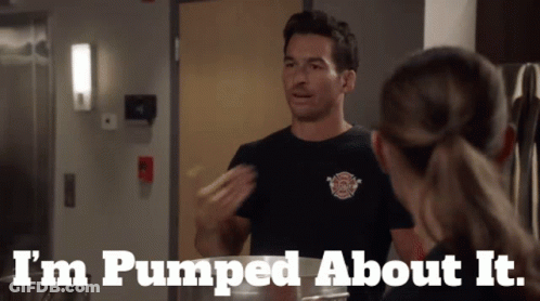 A Man In A Fireman 'S Shirt Says I 'M Pumped About It While Talking To A Woman GIF