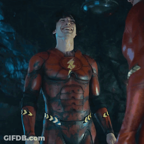A Man In A Flash Costume Is Laughing With The Word Yeah Behind Him GIF