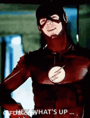 A Man In A Flash Costume Is Standing With His Hands On His Hips And Says `` Hey , What 'S Up ... '' GIF