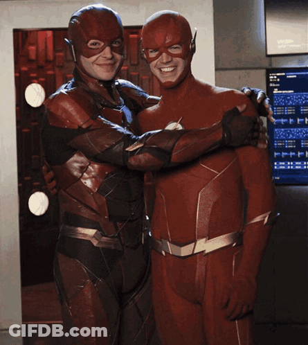 A Man In A Flash Suit Is Hugging Another Man GIF