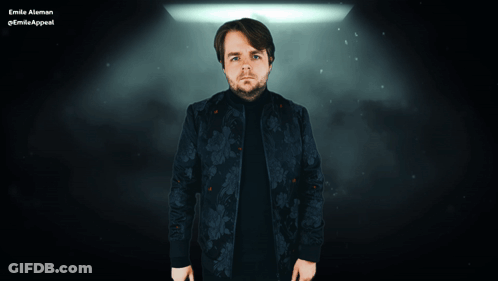 A Man In A Floral Jacket Is Standing In Front Of A Sign That Says D GIF