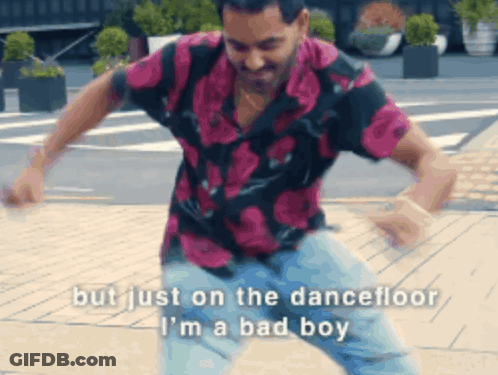 A Man In A Floral Shirt Is Dancing On The Dance Floor GIF