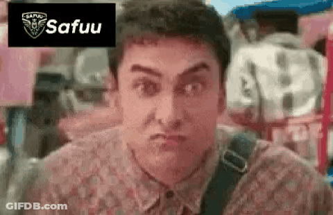 A Man In A Floral Shirt Is Making A Funny Face With His Mouth Open . GIF