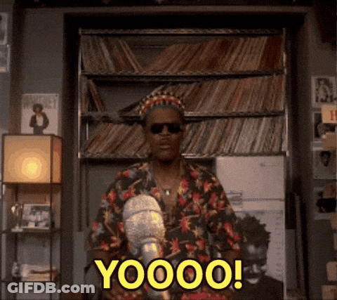 A Man In A Floral Shirt Is Standing In Front Of A Bookshelf And Says Yoooo ! GIF