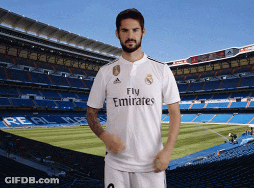 A Man In A Fly Emirates Jersey Stands In Front Of A Soccer Field GIF