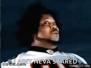 A Man In A Football Jersey Is Looking Up And Saying `` I Ain T Neva Scared '' . GIF