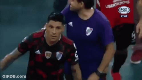 A Man In A Fox Sports Shirt Stands Next To A Man In A Purple Shirt GIF