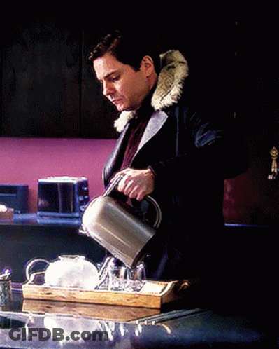A Man In A Fur Coat Is Pouring Tea Into A Cup On A Tray GIF