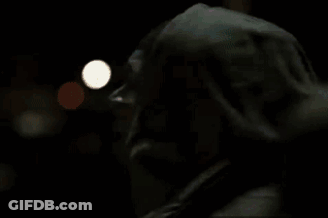 A Man In A Fur Coat Is Talking On A Cell Phone . GIF