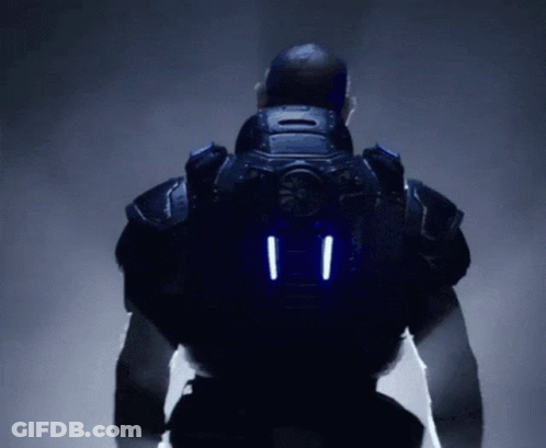 A Man In A Futuristic Suit Has Two Lights On The Back Of His Jacket GIF