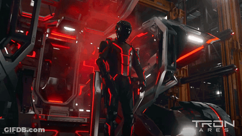 Man In Futuristic Suit In Front Of Tron Sign GIF