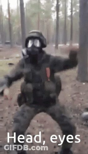 A Man In A Gas Mask Is Dancing In The Woods With The Words Head Eyes Written Below Him GIF