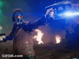 A Man In A Gas Mask Is Standing In Front Of A Fire GIF
