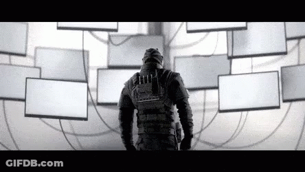 A Man In A Gas Mask Is Standing In Front Of A Wall Filled With Lots Of Empty Boxes . GIF