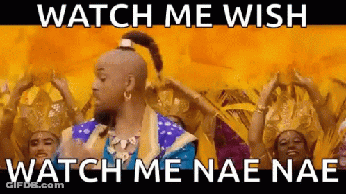 A Man In A Genie Costume Is Dancing In Front Of A Group Of People . GIF