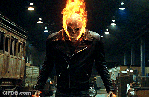 A Man In A Ghost Rider Costume Is Holding A Knife GIF