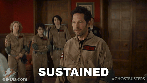 A Man In A Ghostbusters Uniform Says Sustained In Front Of A Group Of People GIF