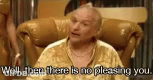 A Man In A Gold Shirt Is Sitting In A Chair And Says `` Well , Then There Is No Pleasing You . '' GIF