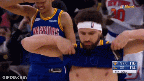 A Man In A Golden State Warriors Jersey Is Being Held By Another Man GIF
