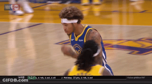 A Man In A Golden State Warriors Jersey Is Kneeling Down GIF