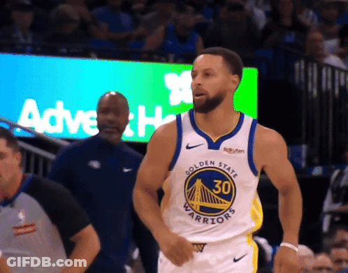 A Man In A Golden State Warriors Jersey Stands In Front Of A Crowd GIF