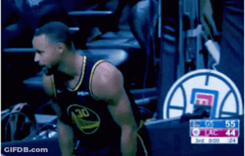 A Man In A Golden State Warriors Jersey Stands In The Stands During A Basketball Game GIF