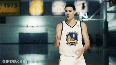 A Man In A Golden State Warriors Jersey Stands On A Court GIF
