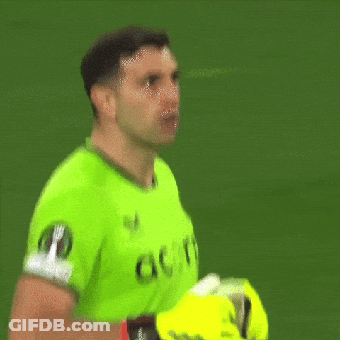 A Man In A Green Acorns Jersey Holds His Gloves Up GIF