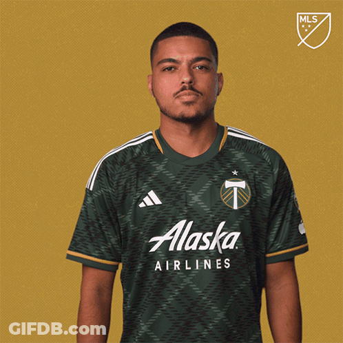 A Man In A Green Alaska Airlines Shirt GIF