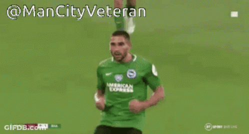 A Man In A Green American Express Jersey Is Covering His Face With His Hands GIF